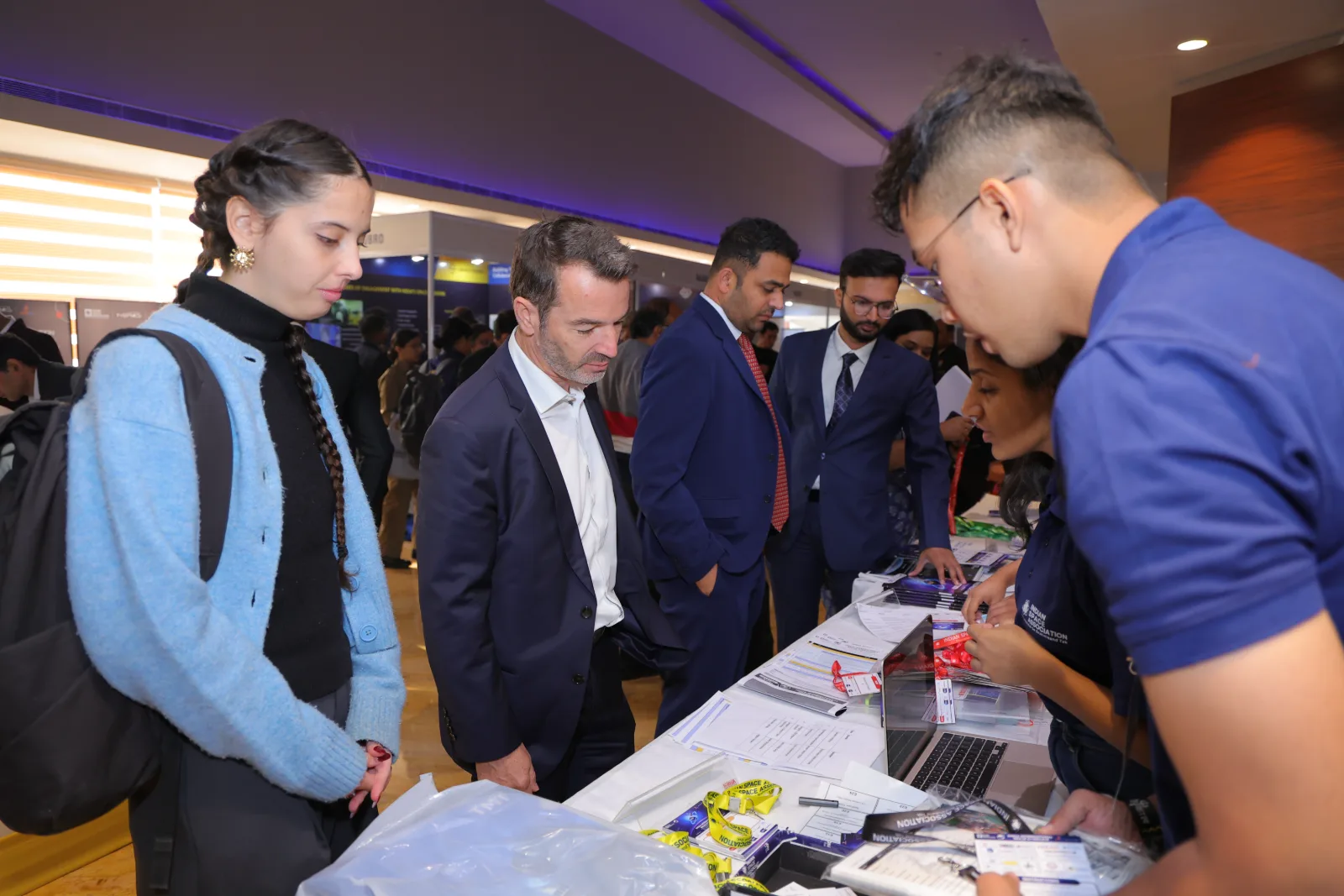 Delegates collecting their badges at the IISC 2025 registration desk